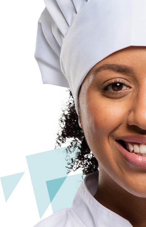 smiling woman wearing white chef hat